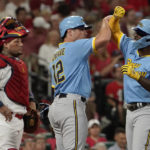 
              Milwaukee Brewers' Andrew McCutchen, right, is congratulated by teammate Hunter Renfroe (12) after hitting a two-run home run as St. Louis Cardinals catcher Yadier Molina stands by during the fifth inning of a baseball game Tuesday, Sept. 13, 2022, in St. Louis. (AP Photo/Jeff Roberson)
            