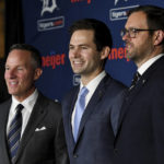 
              Detroit Tigers Chairman and CEO Christopher Ilitch; new Director of Baseball Operations Scott Harris; and Chris McGowan, president and CEO of Ilitch Sports and Entertainment, from left, pose for photos in Detroit on Tuesday, Sept. 20, 2022. (Robin Buckson/Detroit News via AP)
            