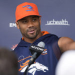 
              Denver Broncos quarterback Russell Wilson jokes with reporters during a news conference before practice at the NFL team's headquarters Wednesday, Sept. 21, 2022, in Centennial, Colo. (AP Photo/David Zalubowski)
            