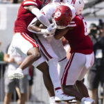 
              Oklahoma's Oklahoma wide receiver Theo Wease Jr., center, catches a touchdown pass between coverage by Nebraska's Quinton Newsome, left, and Myles Farmer during the second half of an NCAA college football game Saturday, Sept. 17, 2022, in Lincoln, Neb. Oklahoma defeated Nebraska 49-14. (AP Photo/Rebecca S. Gratz)
            