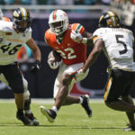 
              Miami running back Thaddius Franklin Jr. (22) runs for yardage against Southern Miss linebacker Averie Habas (46) and safety Jay Jones (5) during the second half of an NCAA college football game, Saturday, Sept. 10, 2022, in Miami Gardens, Fla. (AP Photo/Wilfredo Lee)
            
