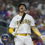 
              San Diego Padres' Juan Soto reacts after a swinging strike during the seventh inning of the team's baseball game against the Los Angeles Dodgers, Thursday, Sept. 29, 2022, in San Diego. (AP Photo/Gregory Bull)
            