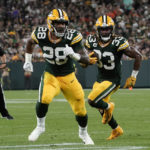 
              Green Bay Packers running back Aaron Jones (33) runs behind teammate running back AJ Dillon (28) during an 8-yard touchdown reception during the first half of an NFL football game against the Chicago Bears Sunday, Sept. 18, 2022, in Green Bay, Wis. (AP Photo/Morry Gash)
            