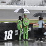 
              Kyle Busch stands next to his car on pit road after a thunderstorm caused a red flag stoppage during a NASCAR Cup Series auto race at Daytona International Speedway, Sunday, Aug. 28, 2022, in Daytona Beach, Fla. (AP Photo/Terry Renna)
            