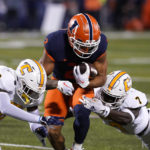 
              Illinois running back Chase Brown is tackled by Chattanooga defensive backs Jordan Walker, left, and Reuben Lowery III, during the first half of an NCAA college football game Thursday, Sept. 22, 2022, in Champaign, Ill. (AP Photo/Charles Rex Arbogast)
            