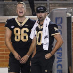 
              Injured Wake Forest players Sam Hartman (10) and Michael Frogge (86) react to a play against VMI during the second half of an NCAA college football game in Winston-Salem, N.C., Thursday, Sept. 1, 2022. (AP Photo/Chuck Burton)
            