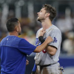 
              Los Angeles Dodgers' Trea Turner talks with a team official after getting hit by the ball while stealing second base during the fifth inning of the team's baseball game against the San Diego Padres, Friday, Sept. 9, 2022, in San Diego. (AP Photo/Gregory Bull)
            