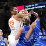 
              Connecticut Sun's Alyssa Thomas (25) shoots as Chicago Sky's Courtney Vandersloot (22) and Candace Parker defend during the first half of Game 5 in a WNBA basketball playoffs semifinal Thursday, Sept. 8, 2022, in Chicago. (AP Photo/Charles Rex Arbogast)
            
