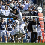 
              Penn State tight end Brenton Strange (86) hurdles Central Michigan defenders Lavario Wiley (6) and Justin Whiteside (45) during the first half of an NCAA college football game, Saturday, Sept. 24, 2022, in State College, Pa. (AP Photo/Barry Reeger)
            