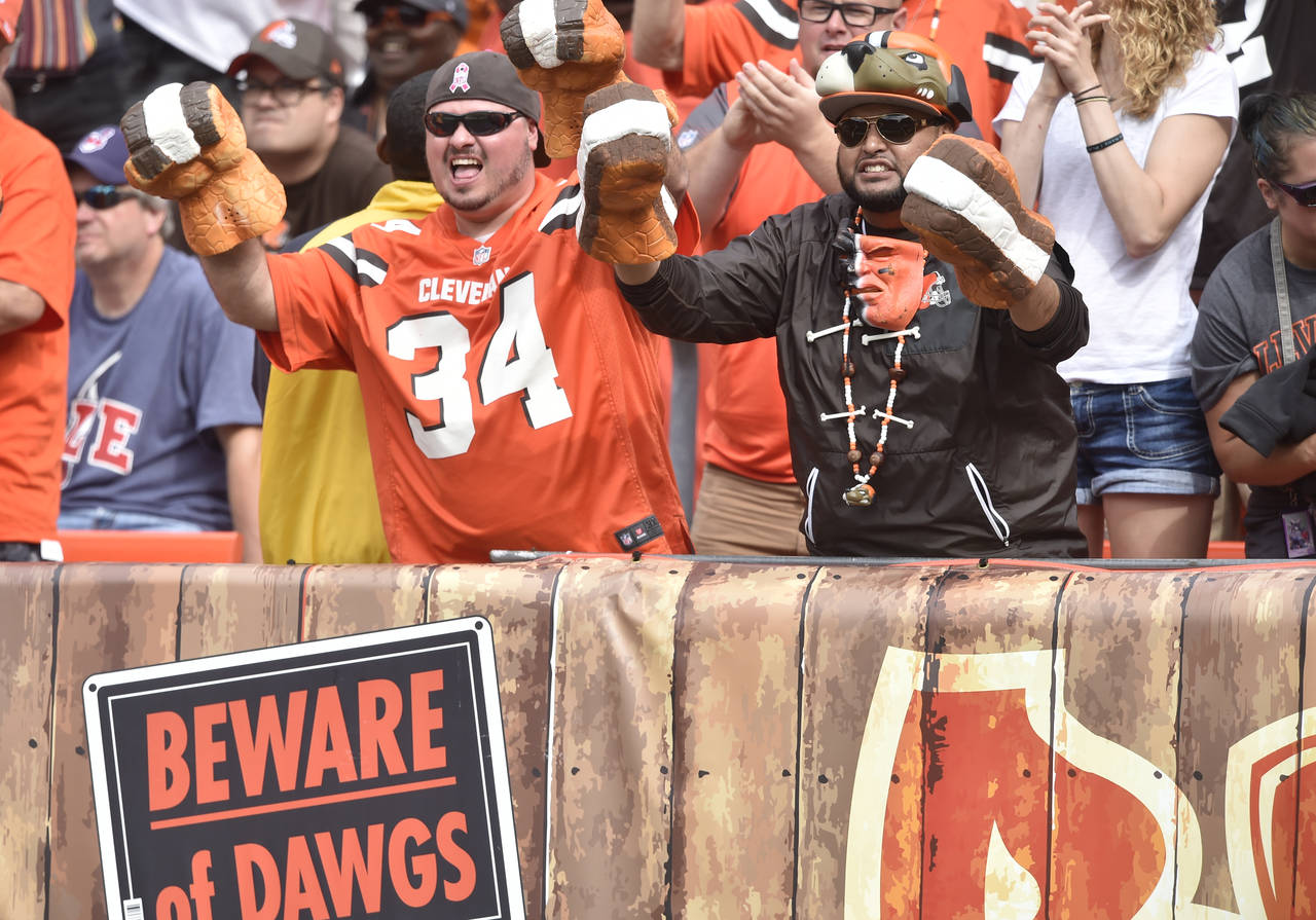 FILE - Fans cheer in the Dawg Pound end zone seats during an NFL football game between the Clevelan...