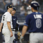 
              New York Yankees relief pitcher Clay Holmes (35) and catcher Kyle Higashioka, second from left, react after defeating the Tampa Bay Rays in a baseball game Sunday, Sept. 11, 2022, in New York. (AP Photo/Noah K. Murray)
            