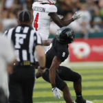 
              Western Kentucky wide receiver Michael Mathison (4) makes a catch over Hawaii defensive back Malik Hausman (9) during the first half of an NCAA college football game Saturday, Sept. 3, 2022, in Honolulu. (AP Photo/Marco Garcia)
            