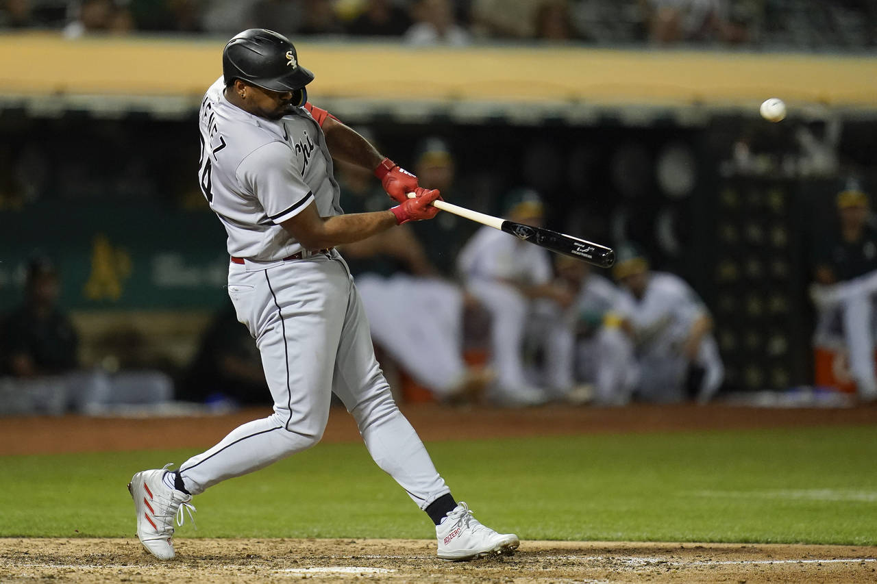Chicago White Sox's Eloy Jiménez hits a two-run home run against the Oakland Athletics during the ...