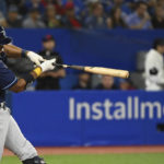 
              Tampa Bay Rays' Yandy Diaz hits a single off Toronto Blue Jays relief pitcher Mitch White during the third inning of the first baseball game of a doubleheader in Toronto, Tuesday, Sept. 13, 2022. (Jon Blacker/The Canadian Press via AP)
            