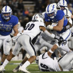 
              Air Force running back Brad Roberts, front top right, runs for yardage against Nevada defensive backs Bentlee Sanders, center, and Aedan Seiuli (46) during the second quarter of an NCAA college football game Friday, Sept. 23, 2022, in Air Force Academy, Colo. (Christian Murdock/The Gazette via AP)
            