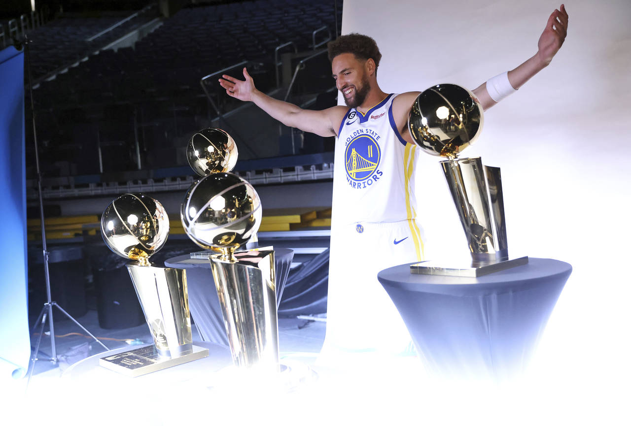 Golden State Warriors' Klay Thompson poses with four Larry O'Brien trophies during Media Day at Cha...
