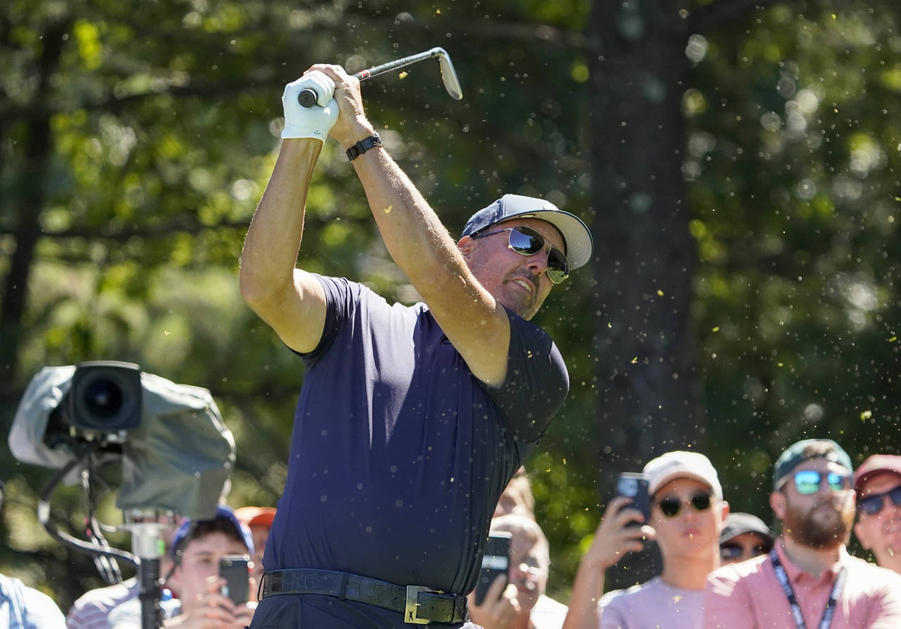 Phil Mickelson follows through on a tee shot on the second hole during the first round of the LIV G...