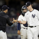 
              New York Yankees pitcher Gerrit Cole hands the ball to manager Aaron Boone during the seventh inning of the second baseball game of a doubleheader against the Minnesota Twins on Wednesday, Sept. 7, 2022, in New York. (AP Photo/Adam Hunger)
            