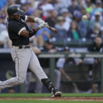 
              Chicago White Sox's Elvis Andrus hits a double during the fifth inning of a baseball game against the Seattle Mariners, Monday, Sept. 5, 2022, in Seattle. (AP Photo/Ted S. Warren)
            