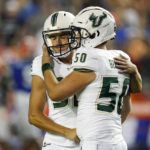 
              South Florida place kicker Spencer Shrader, left, is consoled by long snapper Bryce Bernard (50) after he missed a field goal that would have tied an NCAA college football game against Florida in the closing moments, Saturday, Sept. 17, 2022, in Gainesville, Fla. (AP Photo/John Raoux)
            