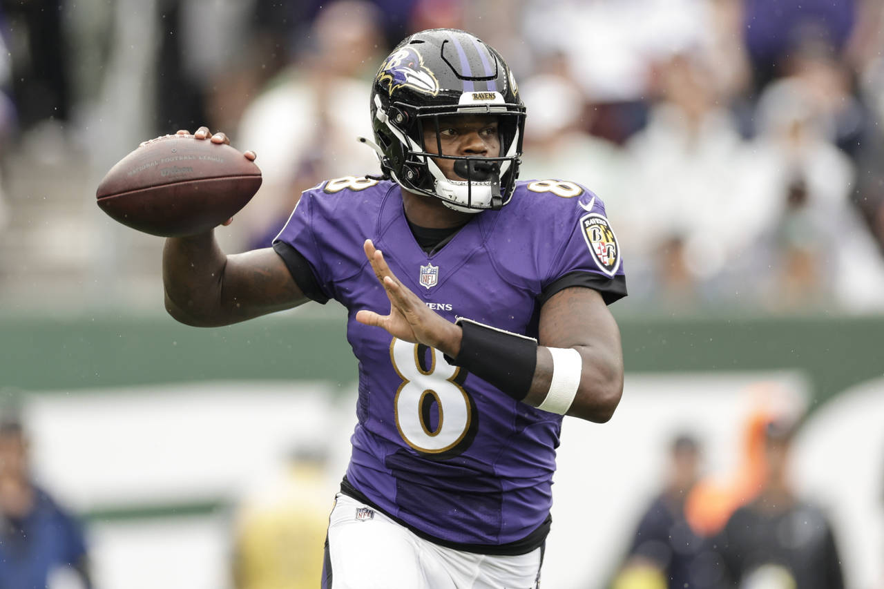 Baltimore Ravens quarterback Lamar Jackson (8) looks to throw a pass during the first half of an NF...