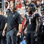 
              North Carolina State head coach Dave Doeren, left, watches from the sideline next to North Carolina State's Isaiah Moore (1) during the second half of an NCAA college football game against Texas Tech in Raleigh, N.C., Saturday, Sept. 17, 2022. (AP Photo/Karl B DeBlaker)
            