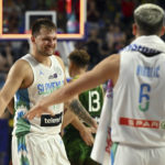 
              Slovenia's Luka Doncic, left, celebrates his team's victory during the Eurobasket group B basketball match Slovenia against Lithuania, in Cologne, Germany, Thursday, Sept. 1, 2022. (Federico Gambarini/dpa via AP)
            