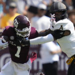 
              Texas A&M wide receiver Evan Stewart (1) tries to fight off a tackle by Appalachian State linebacker Trey Cobb (7) during the first quarter of an NCAA college football game Saturday, Sept. 10, 2022, in College Station, Texas. (AP Photo/Sam Craft)
            