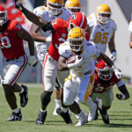 
              Kent State running back Marquez Cooper (1) runs the ball past Georgia defenders Robert Beal Jr. (33) and Malaki Starks (24) in the second half of anNCAA college football game Saturday, Sept. 24, 2022, in Athens, Ga. (AP Photo/John Bazemore)
            