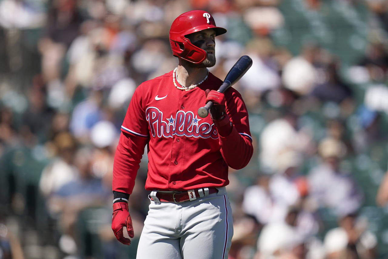 Philadelphia Phillies' Bryce Harper walks to the dugout after striking out against the San Francisc...