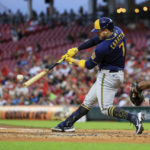 
              Milwaukee Brewers' Victor Caratini hits a double during the second inning of a baseball game against the Cincinnati Reds in Cincinnati, Friday, Sept. 23, 2022.  Brewers' Andrew McCutchen and Luis Urias scored runs on a throwing error by Reds' Aristides Aquino. (AP Photo/Aaron Doster)
            