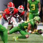 
              Oregon wide receiver Chase Cota (23) makes a catch as Georgia linebacker MJ Sherman (8) defends in the first half of an NCAA college football game game Saturday, Sept. 3, 2022, in Atlanta. (AP Photo/John Bazemore)
            