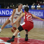 
              France's Marine Fauthoux, left, dribbles the ball through her legs in front of Japan's Mai Yamamoto during their game at the women's Basketball World Cup in Sydney, Australia, Monday, Sept. 26, 2022. (AP Photo/Rick Rycroft)
            