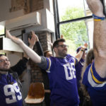 
              Supporters of the the The Minnesota Vikings team cheer at a fan interaction event at The Brotherhood Of Pursuits And Pastimes sports bar in Manchester, England, Wednesday, Sept. 28, 2022. A half-dozen NFL teams are aggressively targeting fans in Britain now that they have new marketing rights in the country. They’re signing commercial deals and hiring local media personalities in bids to expand their fanbases and tap international revenue. (AP Photo/Jon Super)
            