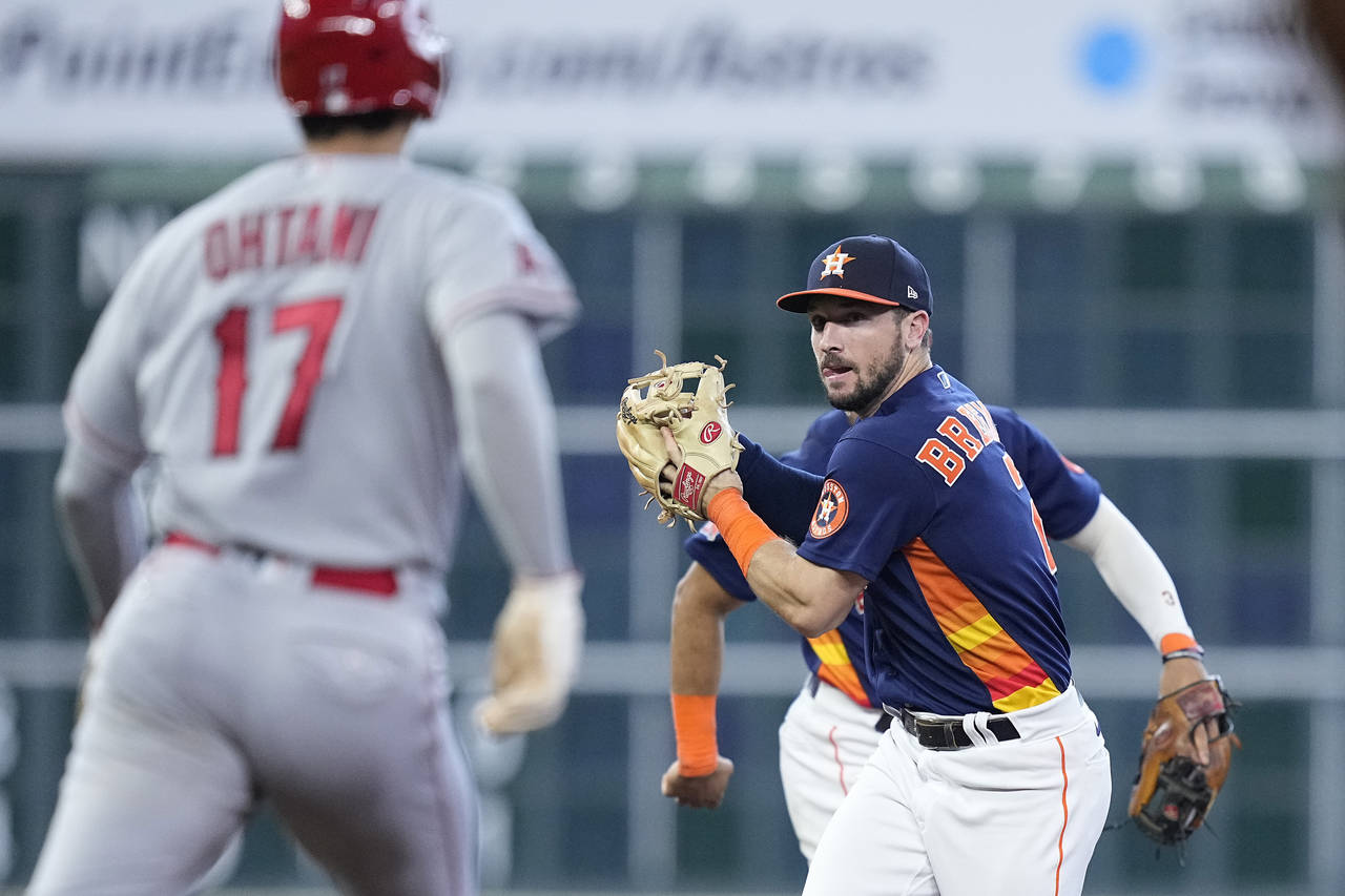 Houston Astros third baseman Alex Bregman, front right, forces out Los Angeles Angels designated hi...