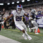 
              New York Giants running back Saquon Barkley (26) reacts after scoring a touchdown against the Dallas Cowboys during the third quarter of an NFL football game, Monday, Sept. 26, 2022, in East Rutherford, N.J. (AP Photo/Adam Hunger)
            