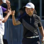
              Ruoning Yin, of China, fist-bumpts a caddie after finishing the first round of the Dana Classic LPGA golf tournament Thursday, Sept. 1, 2022, at Highland Meadows Golf Club in Sylvania, Ohio. (AP Photo/Gene J. Puskar)
            