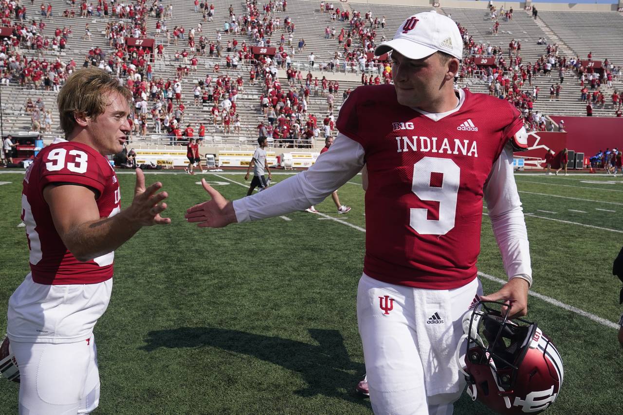 Indiana place kicker Charles Campbell (93) is congratulated by Indiana quarterback Connor Bazelak (...