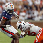 
              Auburn quarterback T.J. Finley (1) is tackled by Mercer linebacker Ken Standley (15) during the first half of an NCAA college football game Saturday, Sept. 3, 2022, in Auburn, Ala. (AP Photo/Butch Dill)
            