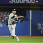 
              New York Yankees shortstop Isiah Kiner-Falefa throws to first for the out on Toronto Blue Jays' Raimel Tapia during the second inning of a baseball game Tuesday, Sept. 27, 2022, in Toronto. (Nathan Denette/The Canadian Press via AP)
            