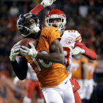 
              FILE - Denver Broncos wide receiver Emmanuel Sanders (10) pulls in a touchdown pass as Kansas City Chiefs cornerback Phillip Gaines defends during the second half of an NFL football game, Sunday, Nov. 27, 2016, in Denver. Sanders announced his retirement Wednesday, Sept. 7, 2022, after a 12-year NFL career that included six season in Denver, where he helped the Broncos win Super Bowl 50. (AP Photo/Jack Dempsey, File)
            