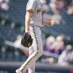 
              Milwaukee Brewers starting pitcher Eric Lauer reacts after giving up a two-run home run to Colorado Rockies' Alan Trejo in the second inning of a baseball game Wednesday, Sept. 7, 2022, in Denver. (AP Photo/David Zalubowski)
            