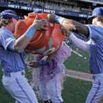 
              Kansas City Royals' Michael Massey is doused by Bobby Witt Jr., left, and MJ Melendez (1) after their baseball game against the Seattle Mariners Sunday, Sept. 25, 2022, in Kansas City, Mo. The Royals won 13-12. (AP Photo/Charlie Riedel)
            