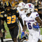 
              Louisiana Tech's Smoke Harris (6) runs with the ball as Missouri linebacker Chad Bailey (33) defends during the first half of an NCAA college football game Thursday, Sept. 1, in Columbia, Mo. (AP Photo/L.G. Patterson)
            