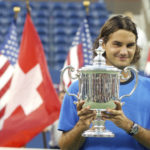 
              FILE - Roger Federer, of Switzerland, poses with the championship trophy after defeating Lleyton Hewitt, of Australia, in the men's singles final at the U.S. Open tennis tournament in New York, Sunday, Sept. 12, 2004. Federer announced Thursday, Sept.15, 2022 he is retiring from tennis. (AP Photo/Richard Drew, File)
            