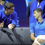 
              Team Europe's Novak Djokovic, right, listens to Roger Federer during a match against Team World's Frances Tiafoe on second day of the Laver Cup tennis tournament at the O2 in London, Saturday, Sept. 24, 2022. (AP Photo/Kin Cheung)
            