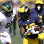 
              Michigan defensive back Rod Moore is chased by Colorado State tight end Tanner Arkin after n interception during the first half of an NCAA college football game, Saturday, Sept. 3, 2022, in Ann Arbor, Mich. (AP Photo/Carlos Osorio)
            