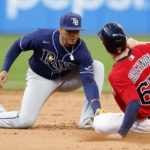 
              Tampa Bay Rays shortstop Wander Franco tags out Cleveland Guardians' Will Brennan attempting to steal second base during the second inning of a baseball game, Tuesday, Sept. 27, 2022, in Cleveland. (AP Photo/Ron Schwane)
            