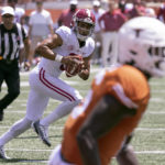 
              Alabama quarterback Bryce Young (9) scrambles out of the backfield before finding running back Jahmyr Gibbs (1) for a touchdown reception against Texas during the second half of an NCAA college football game, Saturday, Sept. 10, 2022, in Austin, Texas. Alabama defeated Texas 20-19. (AP Photo/Rodolfo Gonzalez)
            