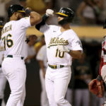 
              Oakland Athletics' Chad Pinder (10) is congratulated by Dermis Garcia (76) after hitting a three-run home run in front of Atlanta Braves catcher William Contreras, right, during the fifth inning of a baseball game in Oakland, Calif., Tuesday, Sept. 6, 2022. (AP Photo/Jed Jacobsohn)
            
